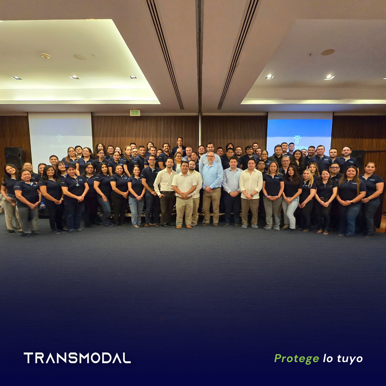 Grupo Transmodal — institutional team photo with tagline 'Protege lo tuyo'
